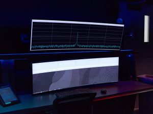 Rows of servers and monitoring displays in a network operations room