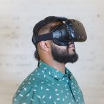 A man wearing an HTC Vive virtual reality headset