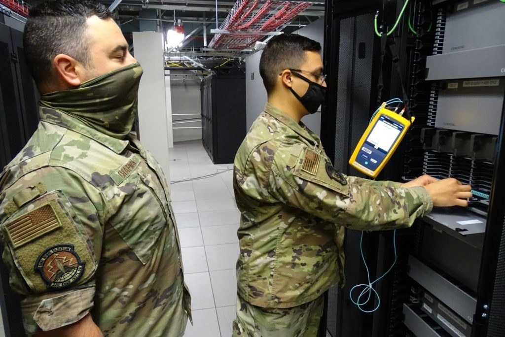 technician installing fiber optic cables for broadband network