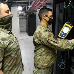 technician installing fiber optic cables for broadband network